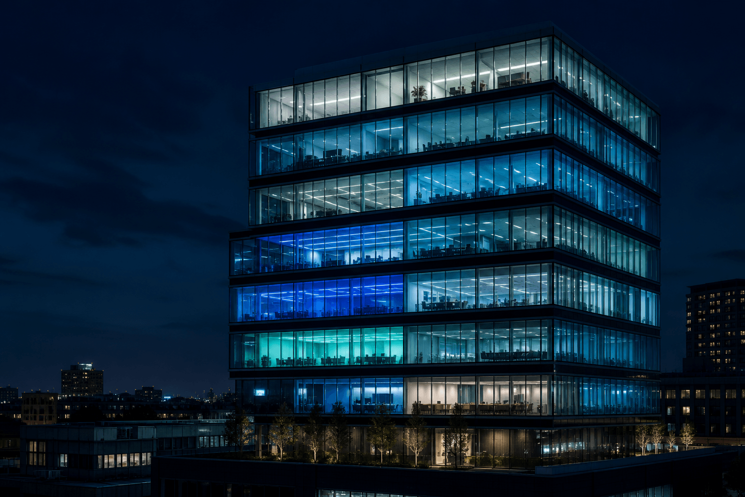 A multi-story building at night, each floor lit separately